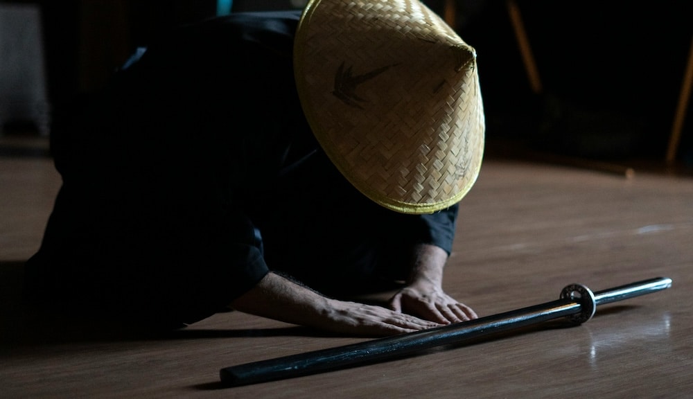 man bows to his katana